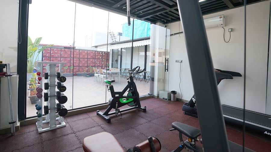 An open gym area with workout equipment and weights at Hotel Kyzen Smartstays – Smart, Reliable, Kyzen