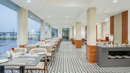 interiors of the Sattva restaurant with comfortable seating at Pride Elite Becharaji