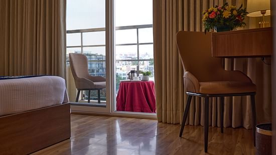 An inviting balcony seen from our hotel room, featuring a chair for relaxation - Grand Continent, Brookefield