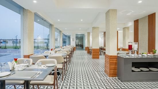 interiors of the Sattva restaurant with comfortable seating at Pride Elite Becharaji