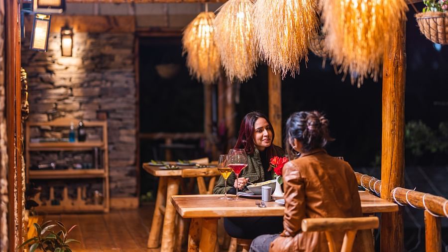  Two women sitting across each other in our outdoor seating arrangement - The Manor Luxury Hotel, Shimla