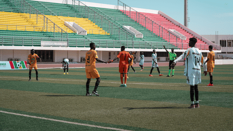 A group of enthusiastic players on field at a football stadium