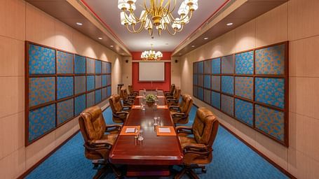 Luxurious dining room with a long table, chandeliers, and traditional decor at GRT