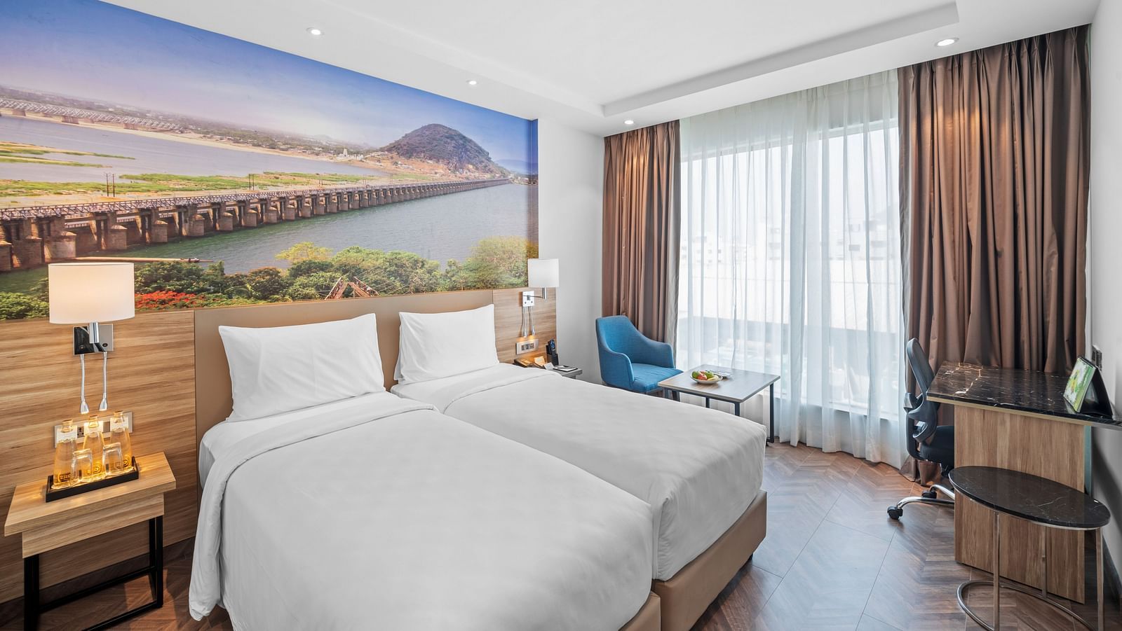 An image of twin beds of a room at Grand Vijayawada by GRT Hotels.