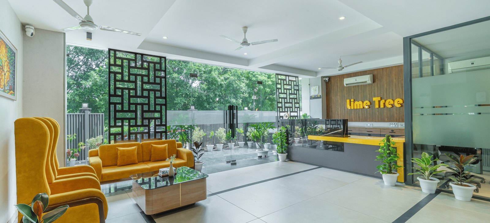 Lobby area featuring cosy chairs and contemporary interiors at Lime Tree Hotel & Stays Greater Noida Nearby India Expo Centre & Mart.