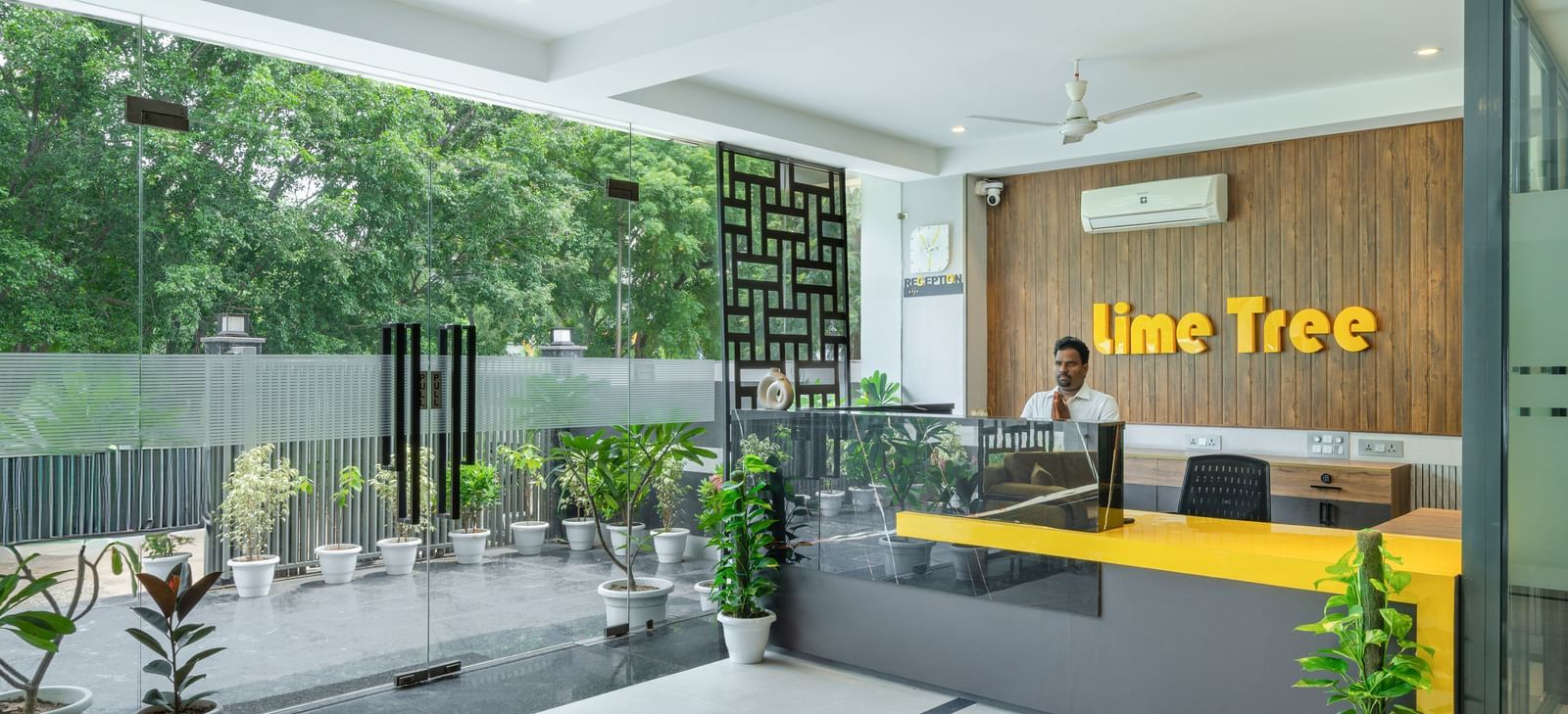 Hotel entrance with plants and stylish front view at Lime Tree Hotel & Stays Greater Noida Nearby India Expo Centre & Mart.