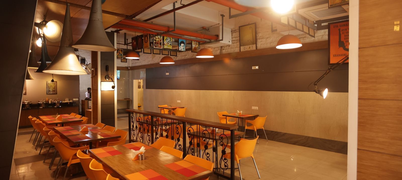 full view image of the dining area with cosy interiors and warm lighting - Max Hotel, Jabalpur