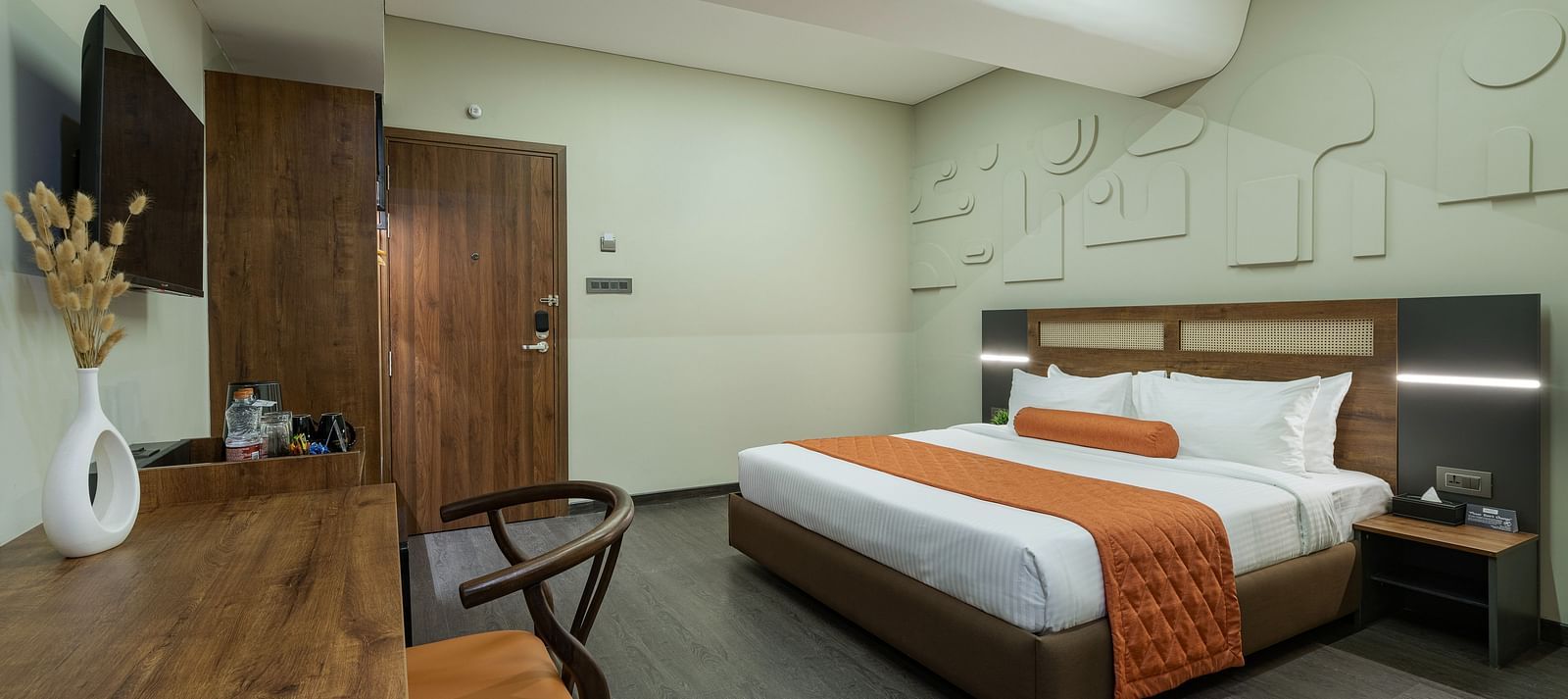 Comfortable Tangerine Room with an in-room safe, a study table and chair alongwith plush beds making a promising stay.