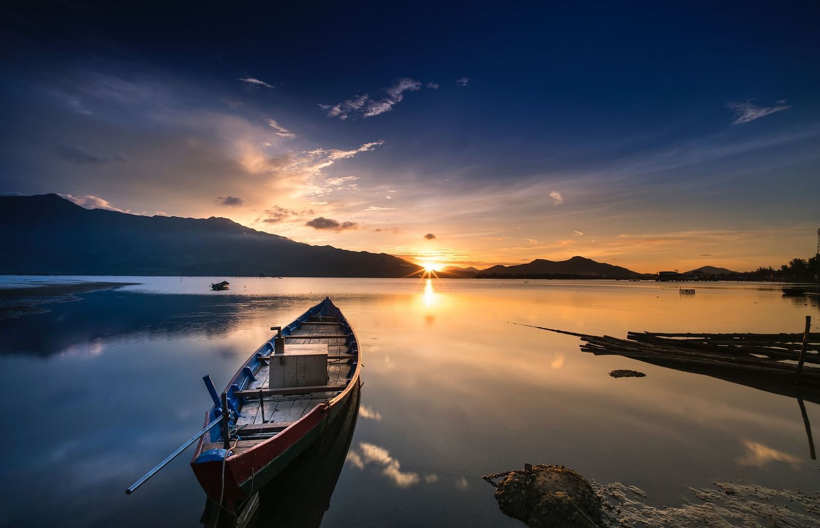 Boat in a lake with sunset backdrop