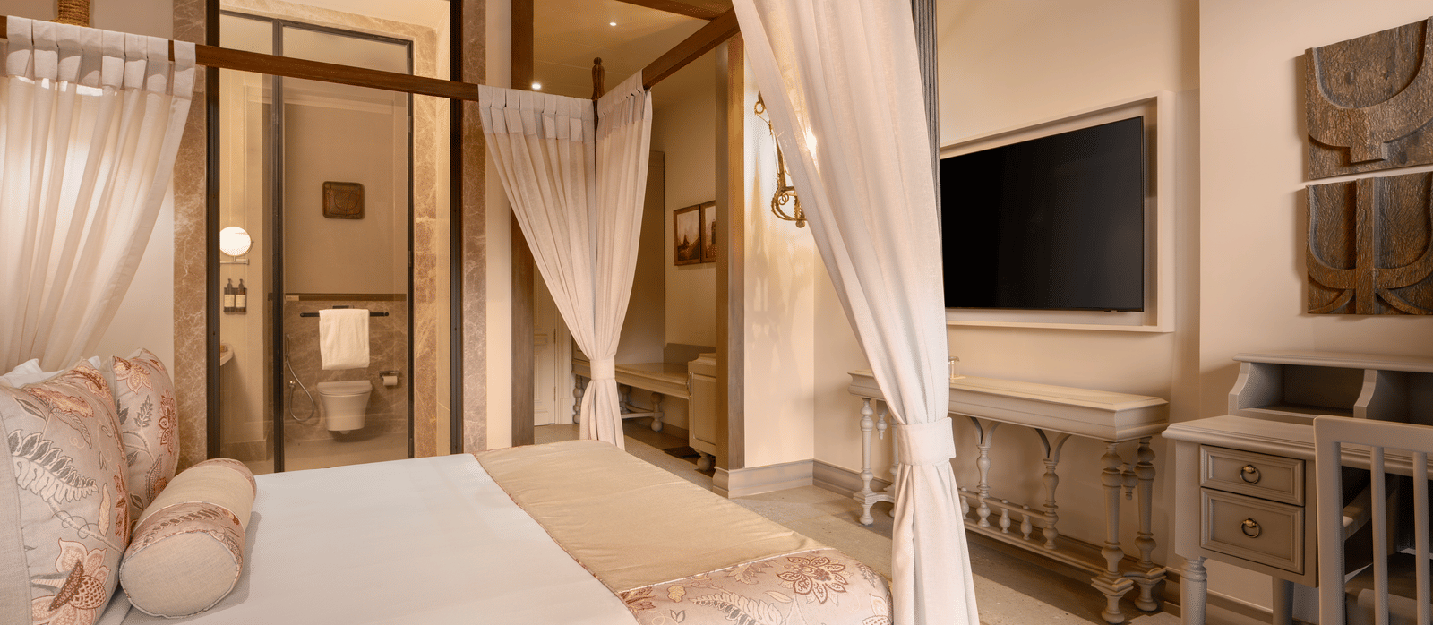 Corner view of the Premium Room featuring a double bed along with a wall mounted television in front of it at The Evren, Vagator.