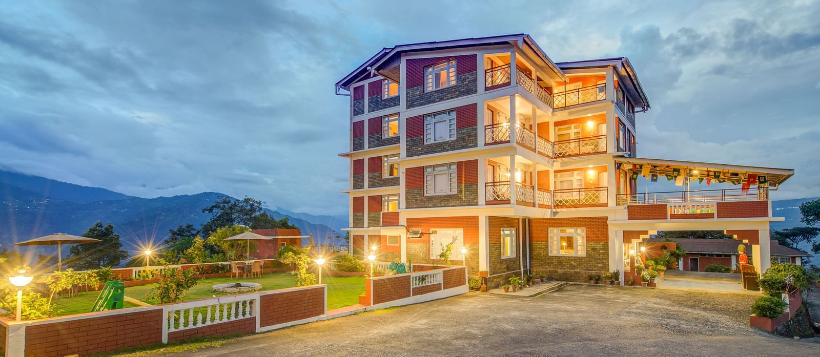 Facade of Summit Tashi Ghang Heritage Resort, Pelling with mountains in the background