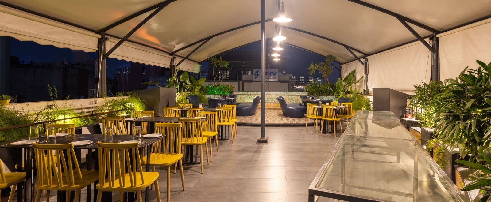 Rooftop dining setup in the Pravasa Cafe at Pravasa Stay Vijay Nagar, Indore.