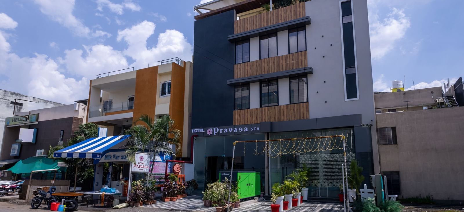 Exterior view of multi-storey Pravasa Stay Dewas Naka, Indore under a partly clouded sky.