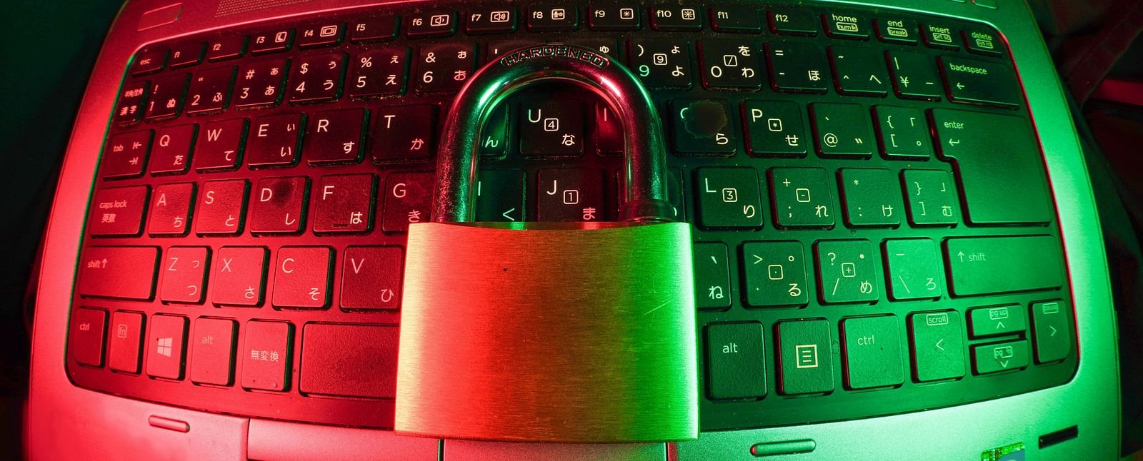 A neon-lit laptop secured with a padlock, symbolizing digital safety