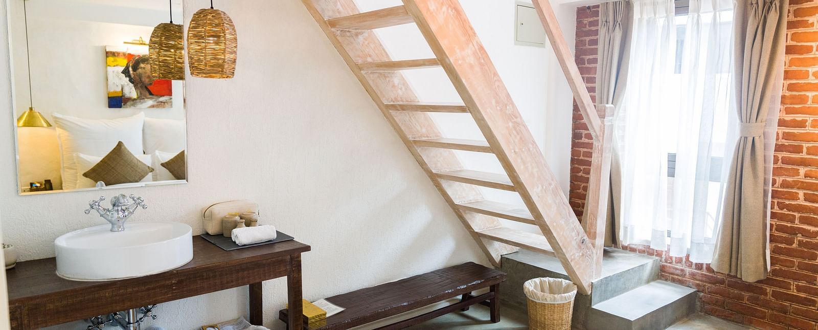 Deluxe loft room where a staircase is leading to the loft and the washroom area in the lower level - The Nanee