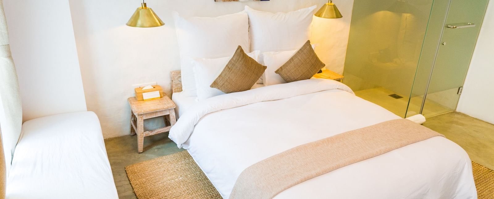 Deluxe loft room with a double bed, and a single bed side tables, and lamps hanging from the ceiling - The Nanee