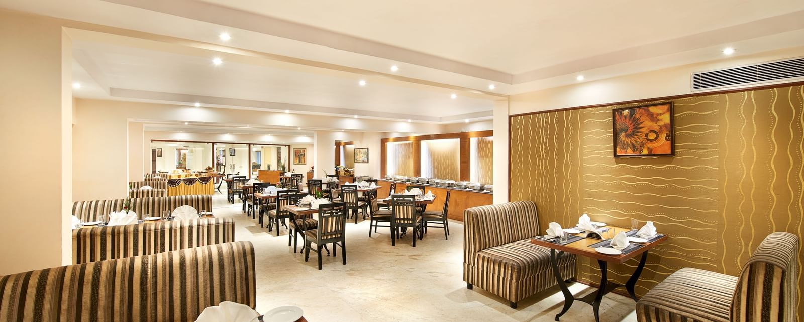 Interiors of a well-lit restaurant at Accord Highland Ooty