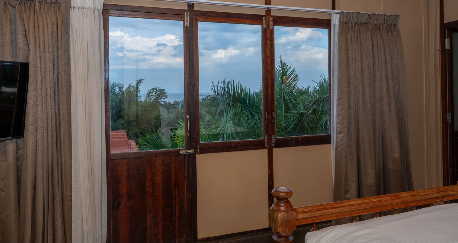 Superior Bedroom  balcony view with curtains.