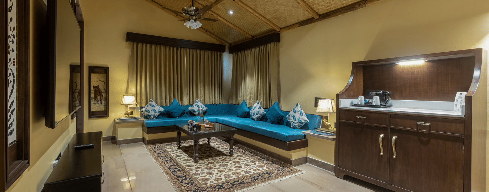 A well appointed bedroom at Aamaghati Wildlife Resort featuring a four poster bed, elegant interiors, and modern comforts for a restful experience.