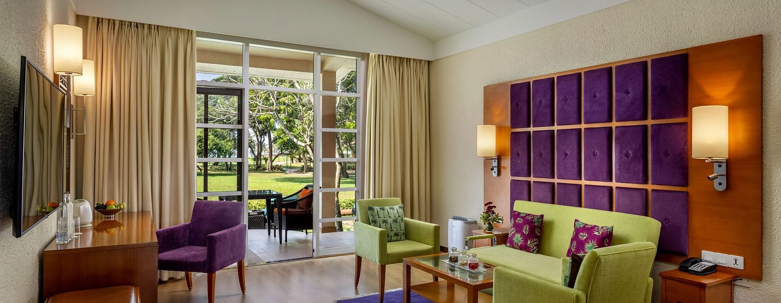 overview of the living room with a sofa and a tv in view inside 2 Bedroom Garden Villa - caravela beach resort goa