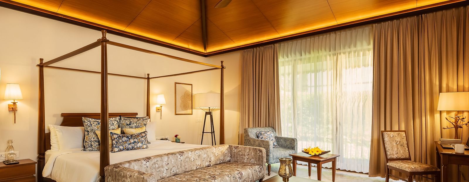 A double bed with side tables and lamps inside Cluster Villa - Gamyam retreat