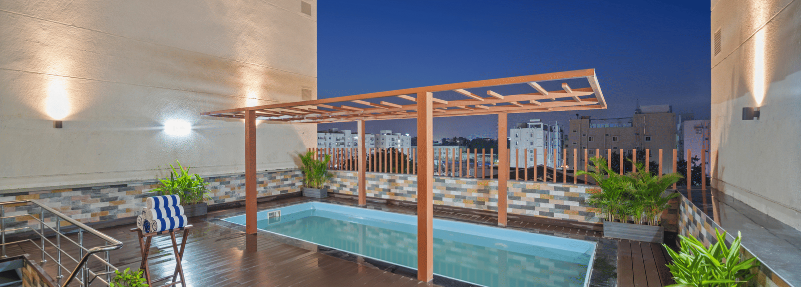 An image of a swimming pool at night of Grand Vijayawada by GRT Hotels.