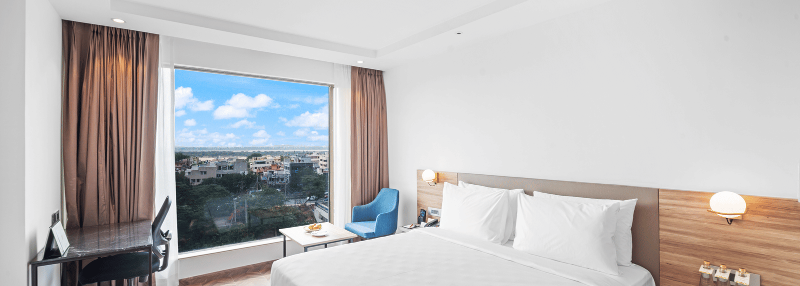 An image of a king size bed of a Grand Club Room at Grand Vijayawada by GRT Hotels.