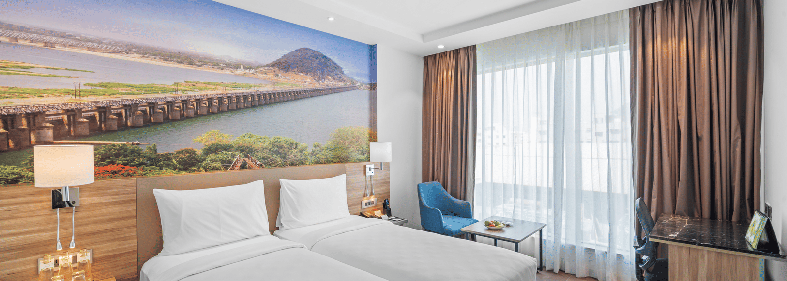 A room featuring two twin beds at Grand Vijayawada by GRT Hotels near Kanaka Durga Temple, Vijayawada.