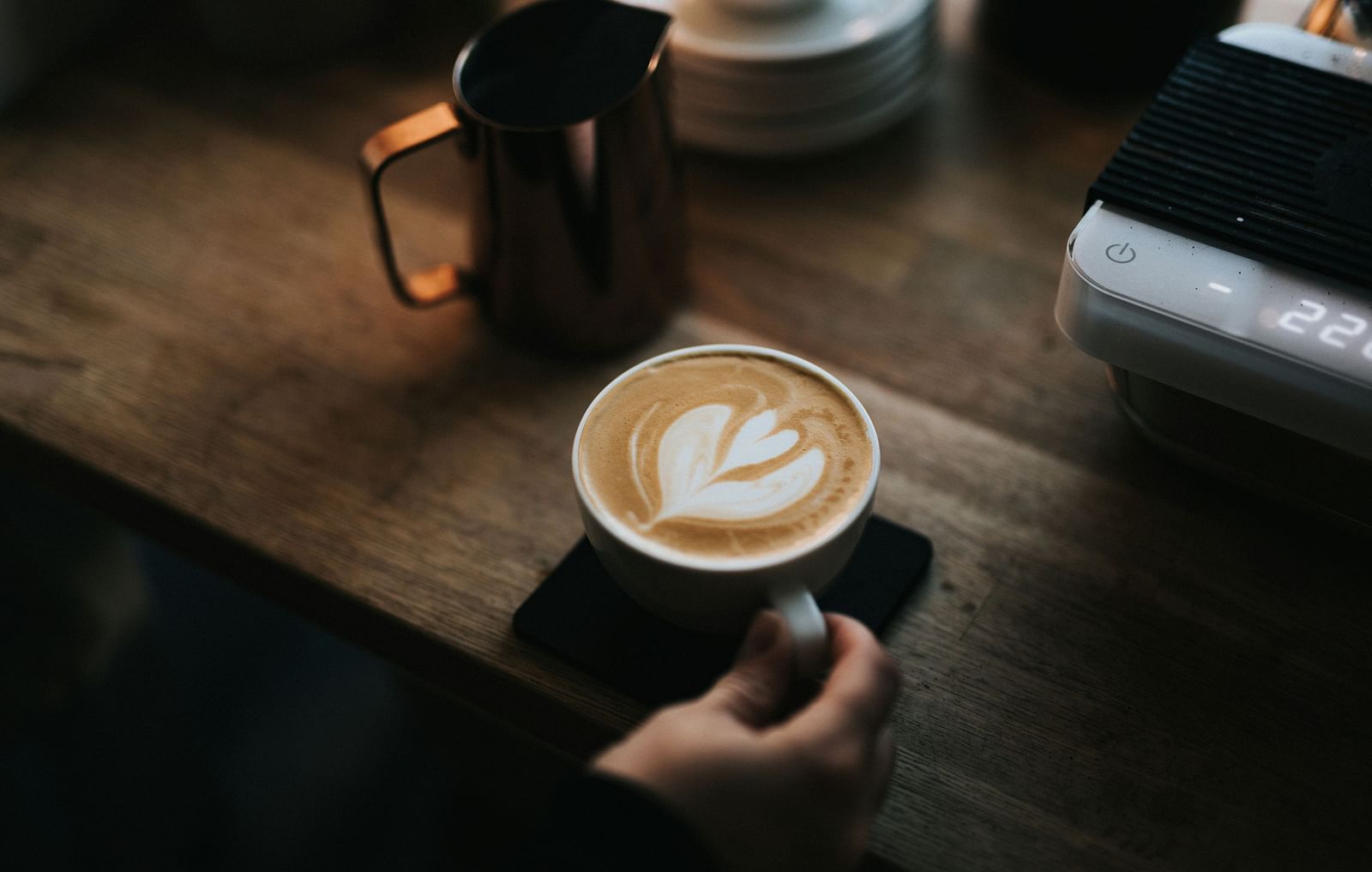 An image of a person holding a coffee cup placed on a table - Hotel 39, Jamaica
