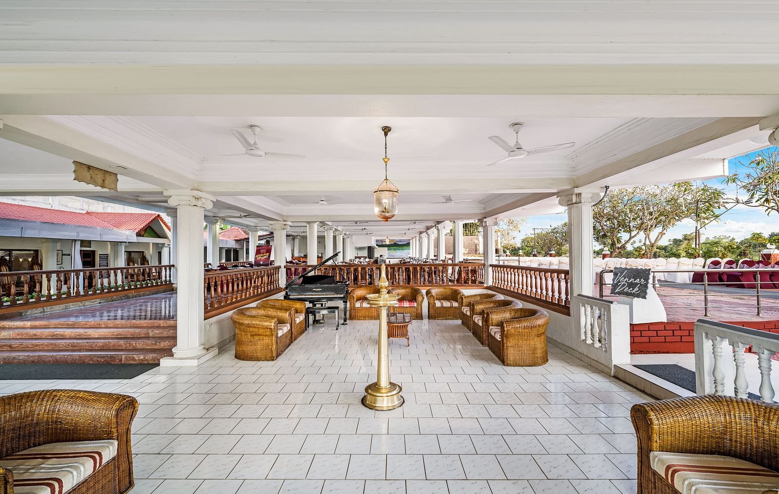 An image of the waiting area with sofa set and table with decoration - GReaT Trails River View Resort Thanjavur By GRT Hotels