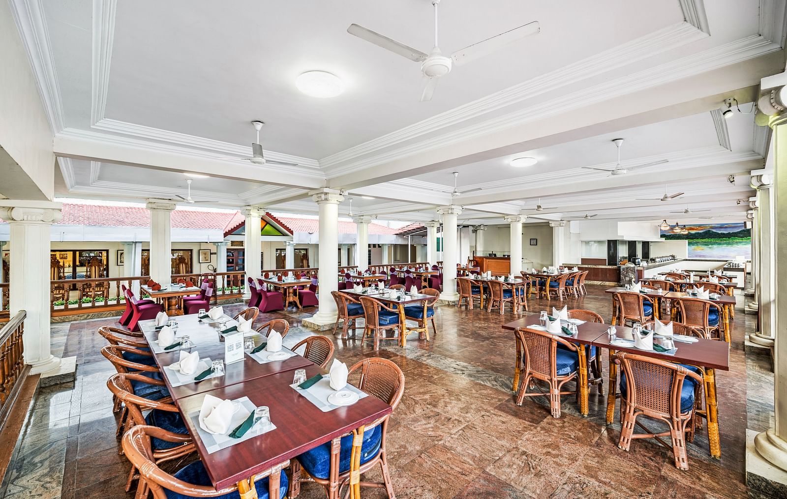 An image of the outdoor dining area featuring tables and chair at GReaT Trails River View Resort Thanjavur By GRT Hotels