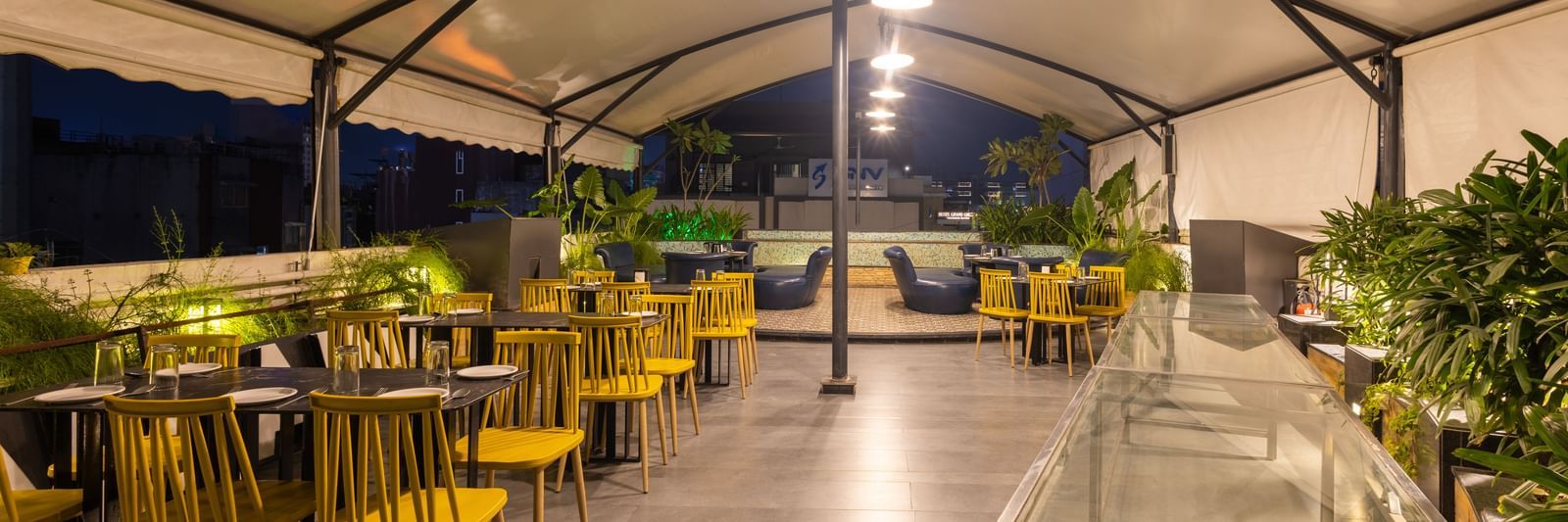 Rooftop dining setup in the Pravasa Cafe at Pravasa Stay Vijay Nagar, Indore.