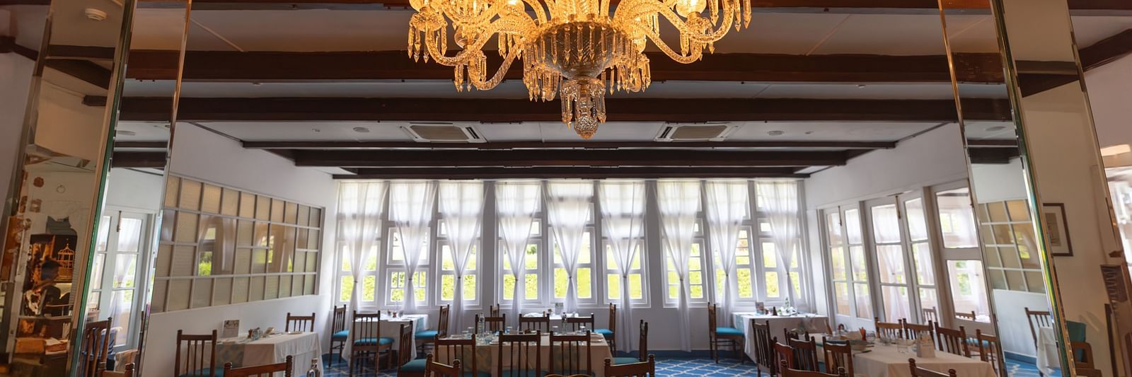 Interiors of Azrak Restaurant at Saraca Hotel, Lucknow with dining arrangement placed in front of large windows