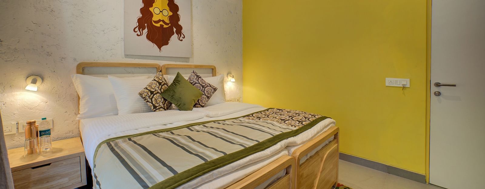 A bedroom a large bed with side lamps - Bedzzz, Rishikesh