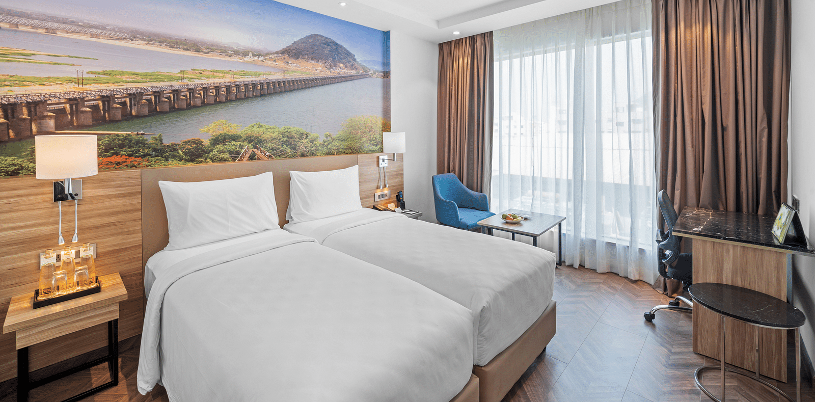 An image of twin beds of a room at Grand Vijayawada by GRT Hotels.