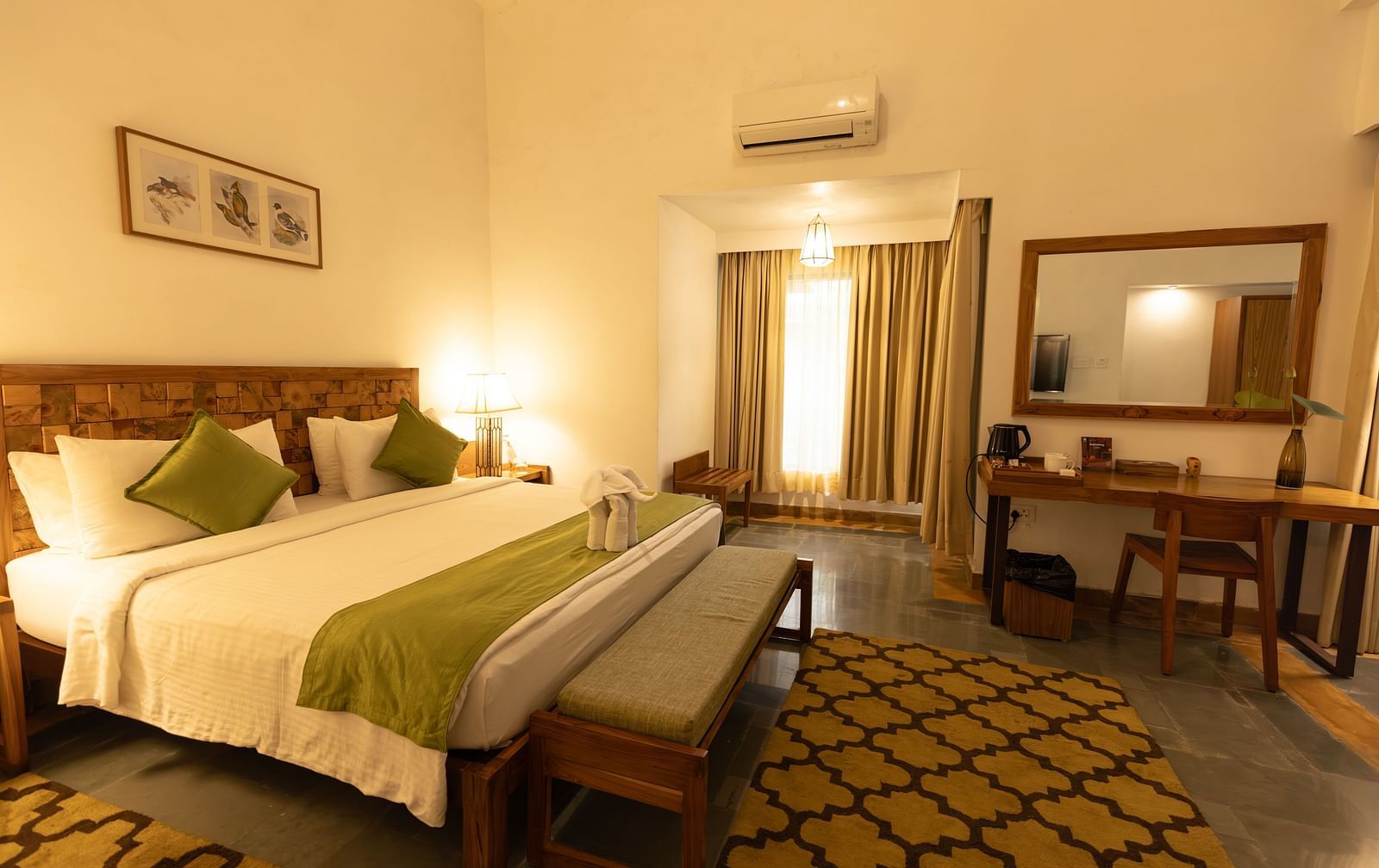 Premium Room at Saraca Resort & Spa Corbett with a double bed surrounded by carpets
