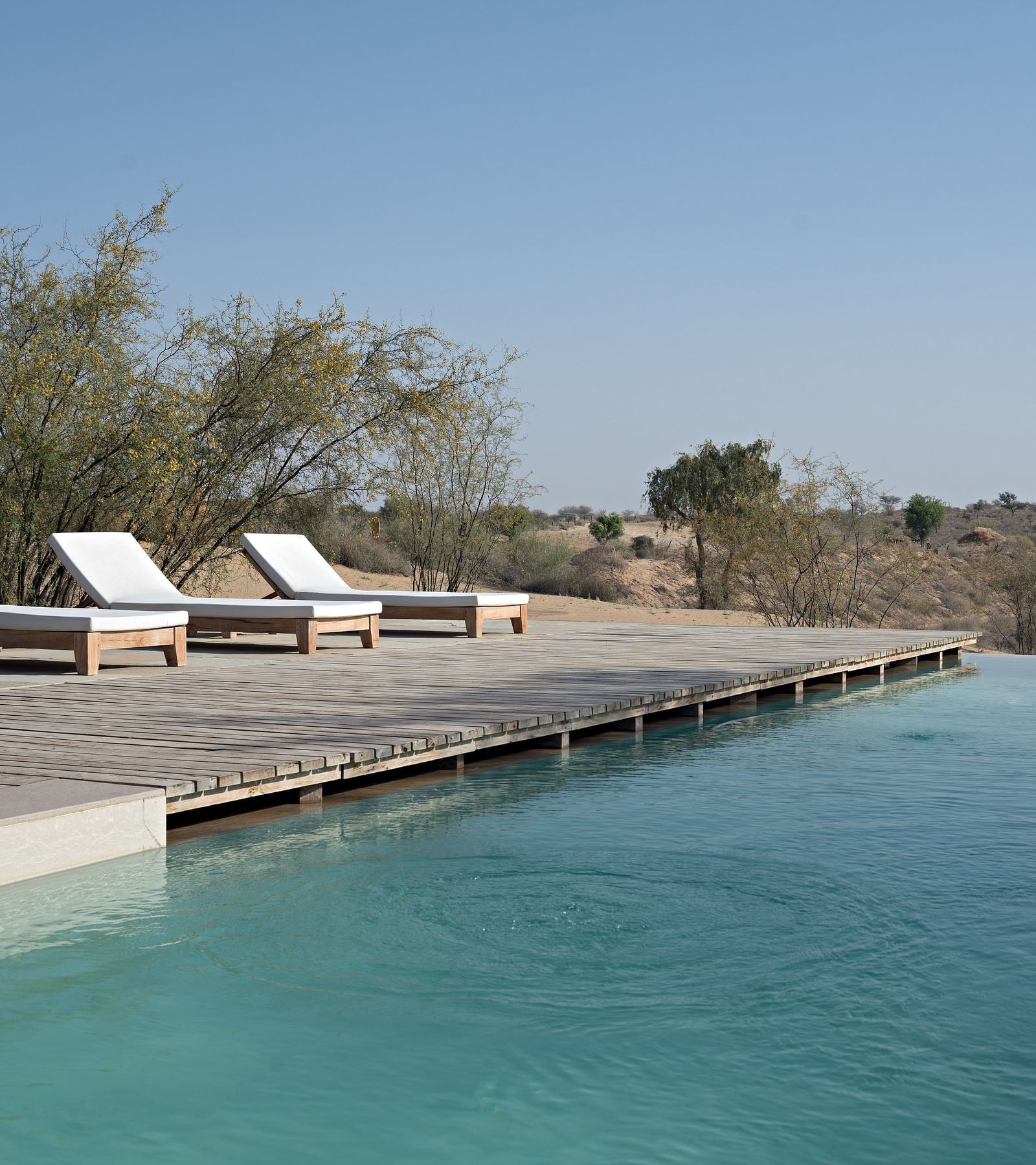Lounging chairs set besides a swimming pool