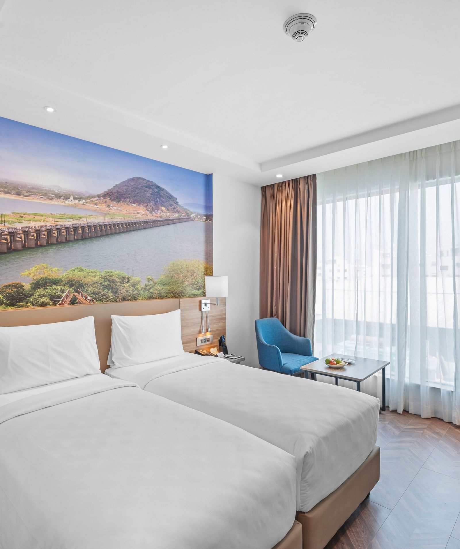 An image of twin beds of a room at Grand Vijayawada by GRT Hotels.