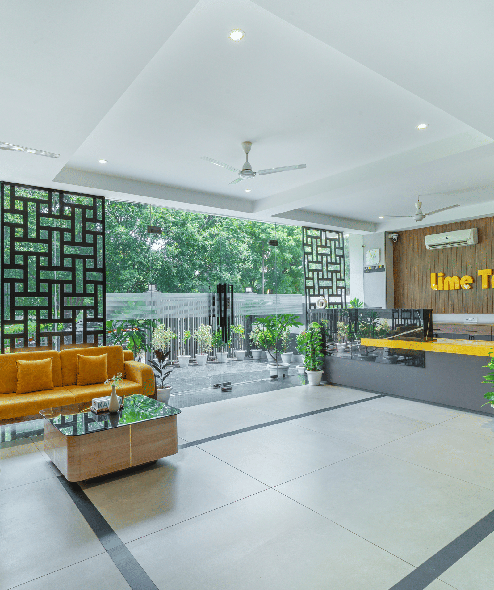 Lobby area featuring cosy chairs and contemporary interiors at Lime Tree Hotel & Stays Greater Noida Nearby India Expo Centre & Mart.