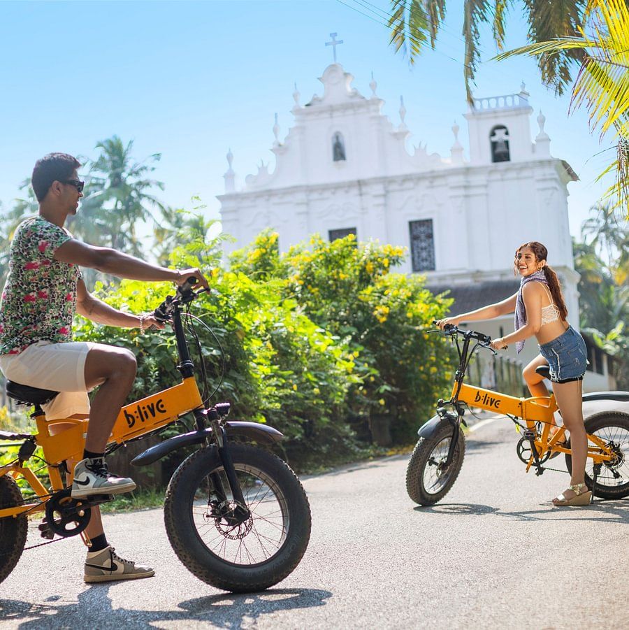 Guests riding electric bikes near the heritage site in Goa.