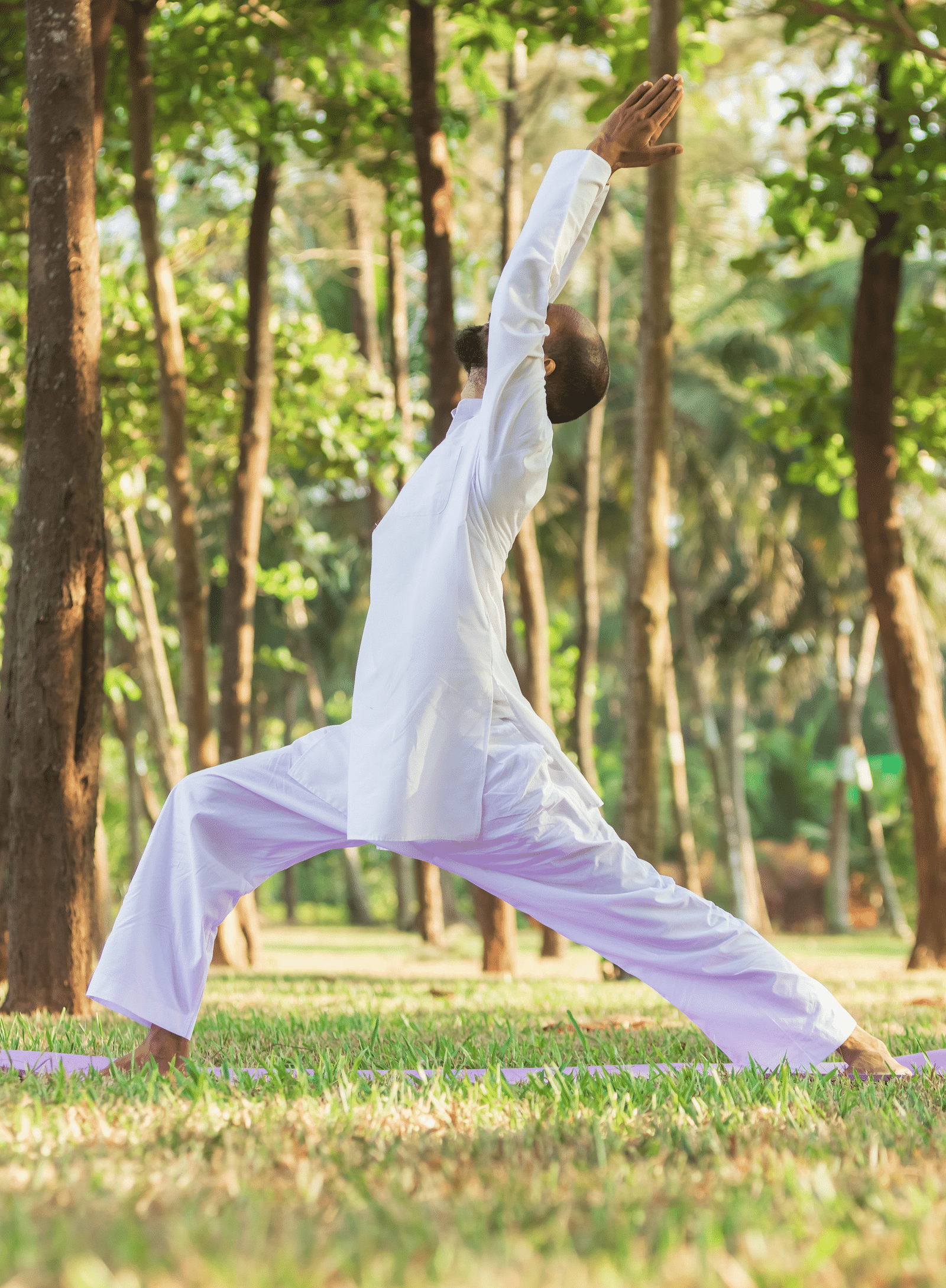 A man in a yoga pose in the open amidst nature
