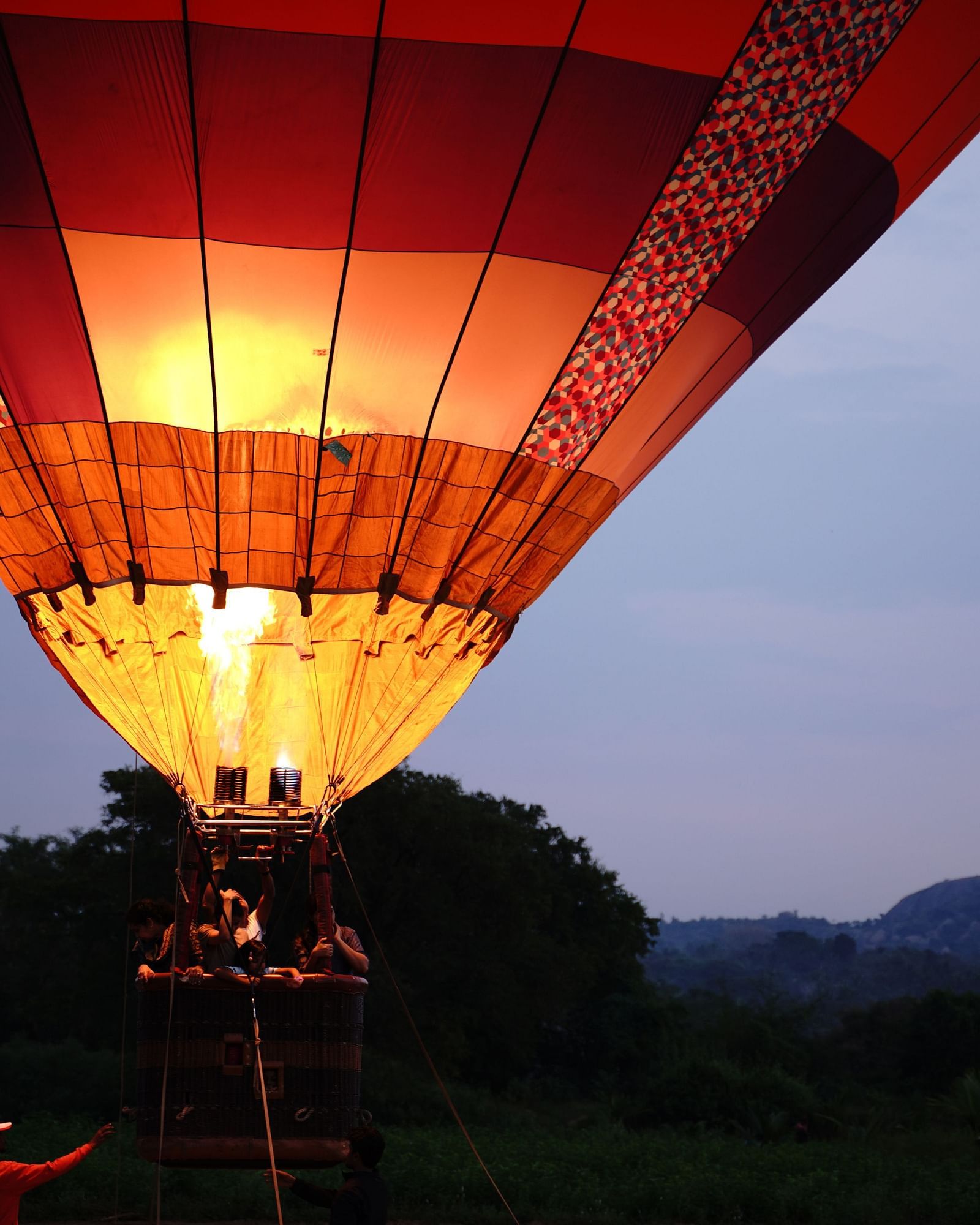 Guests sitting in a hovering hot air balloon during the evening - Ravishing Rtreat, Harisandra