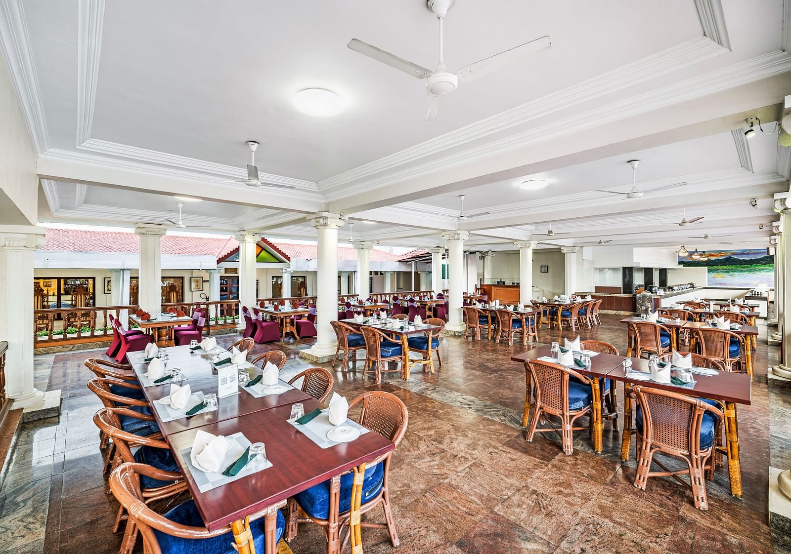 An image of the outdoor dining area featuring tables and chair at GReaT Trails River View Resort Thanjavur By GRT Hotels