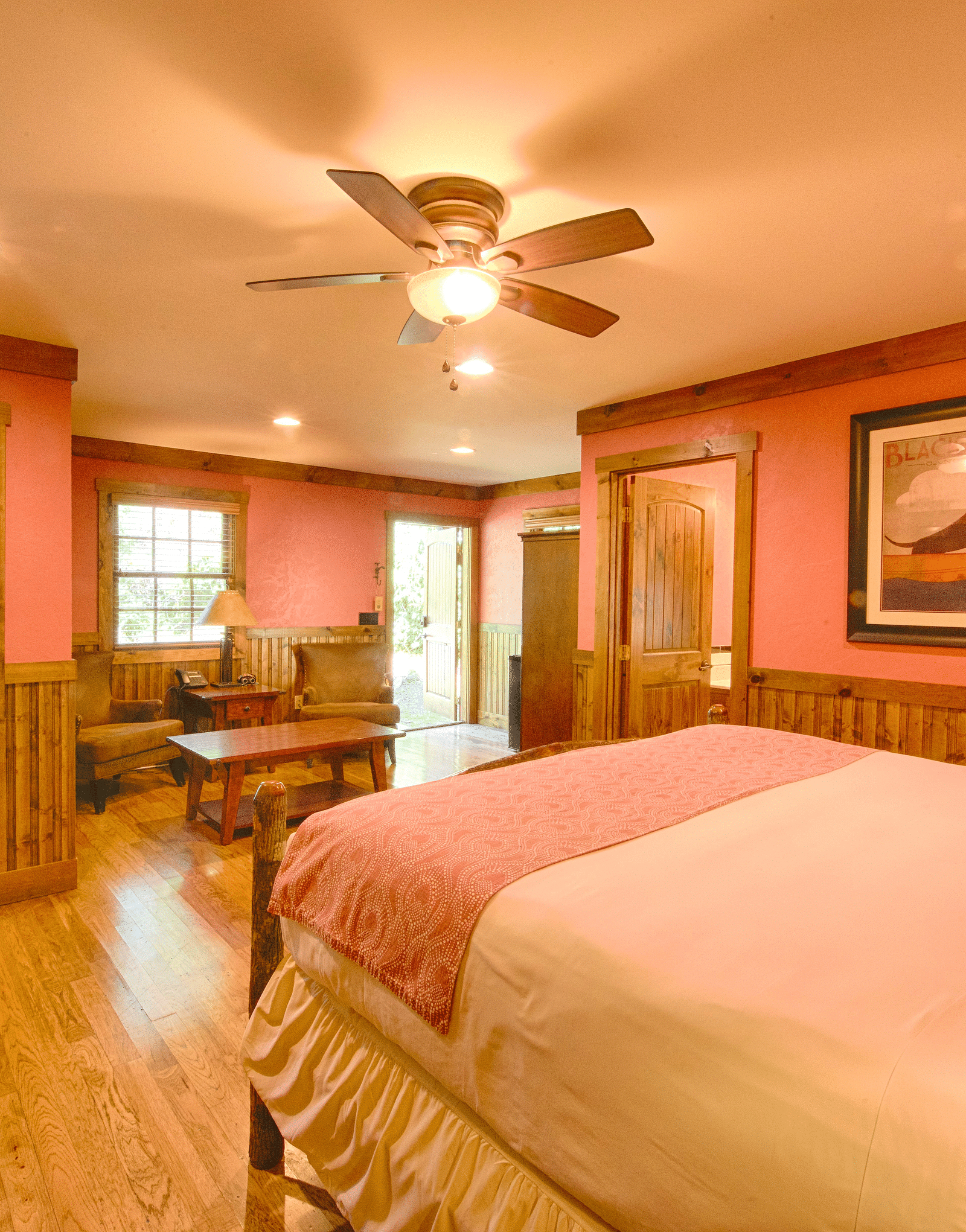 side view image of a room with a double bed featuring a photo frame hanging on the wall - Historic Tapoco Lodge