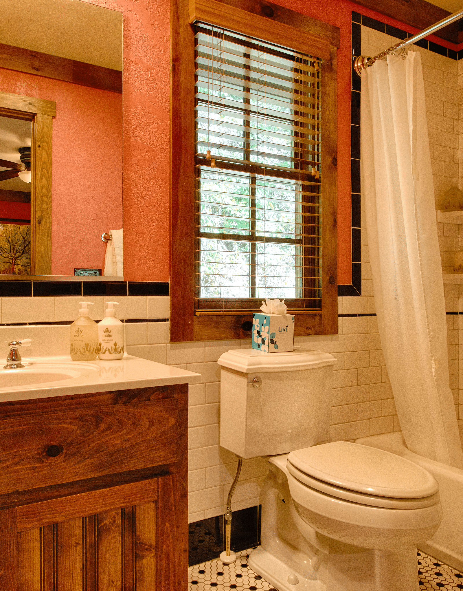a well-furnished bathroom with a vanity area and a bath tub in the Whiteoak Two - Historic Tapoco Lodge