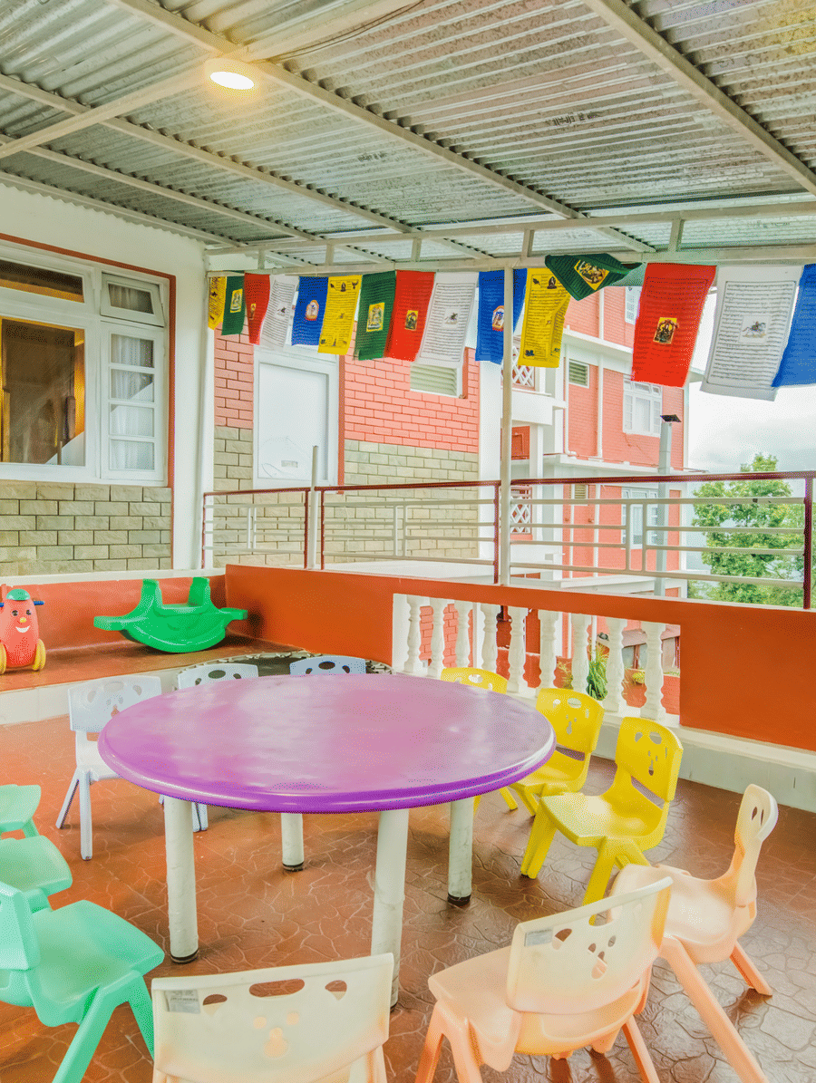 Image of a kids play area with colourful chairs at at Summit Tashi Ghang Heritage Resort, Pelling