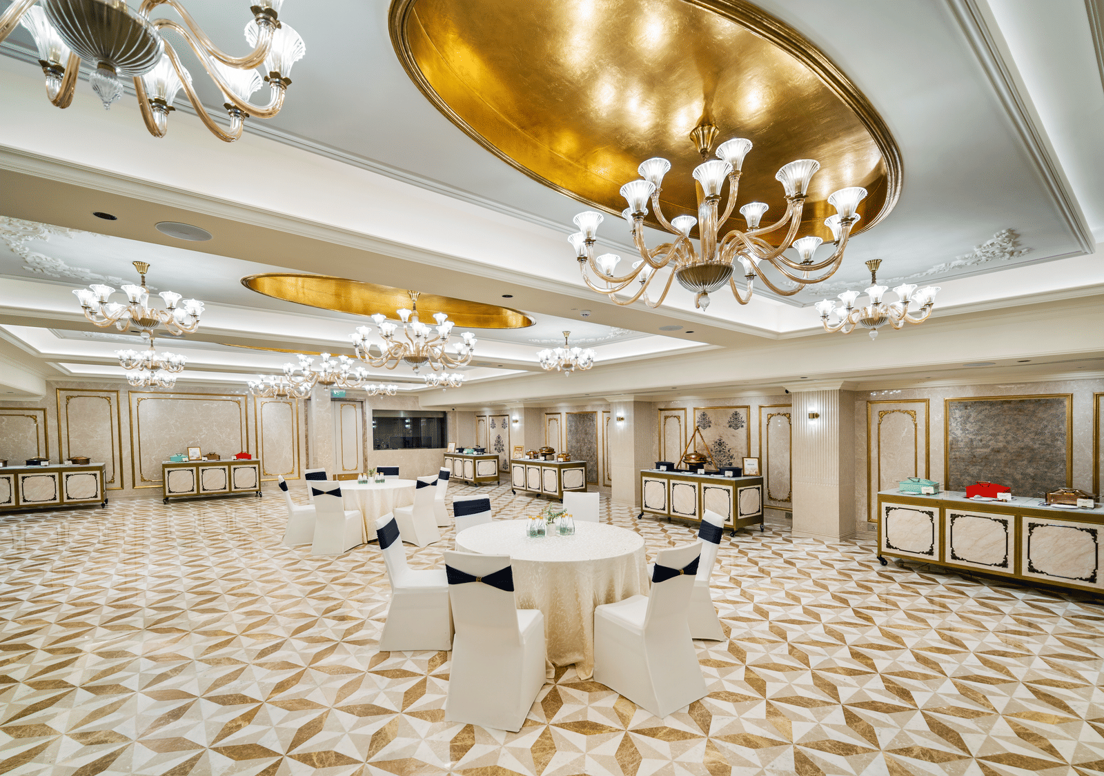 Regalia  luxurious event space with golden ceiling accents at Grand Chennai by GRT Hotels
