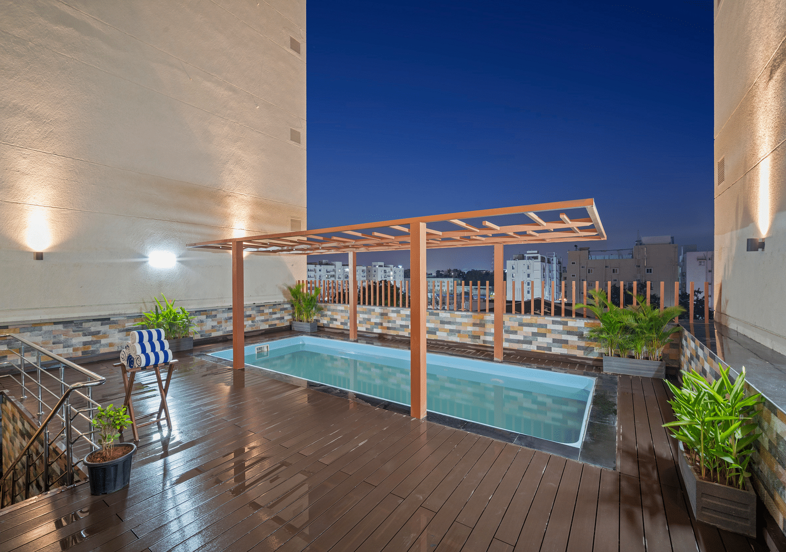 An image of a swimming pool at night of Grand Vijayawada by GRT Hotels.