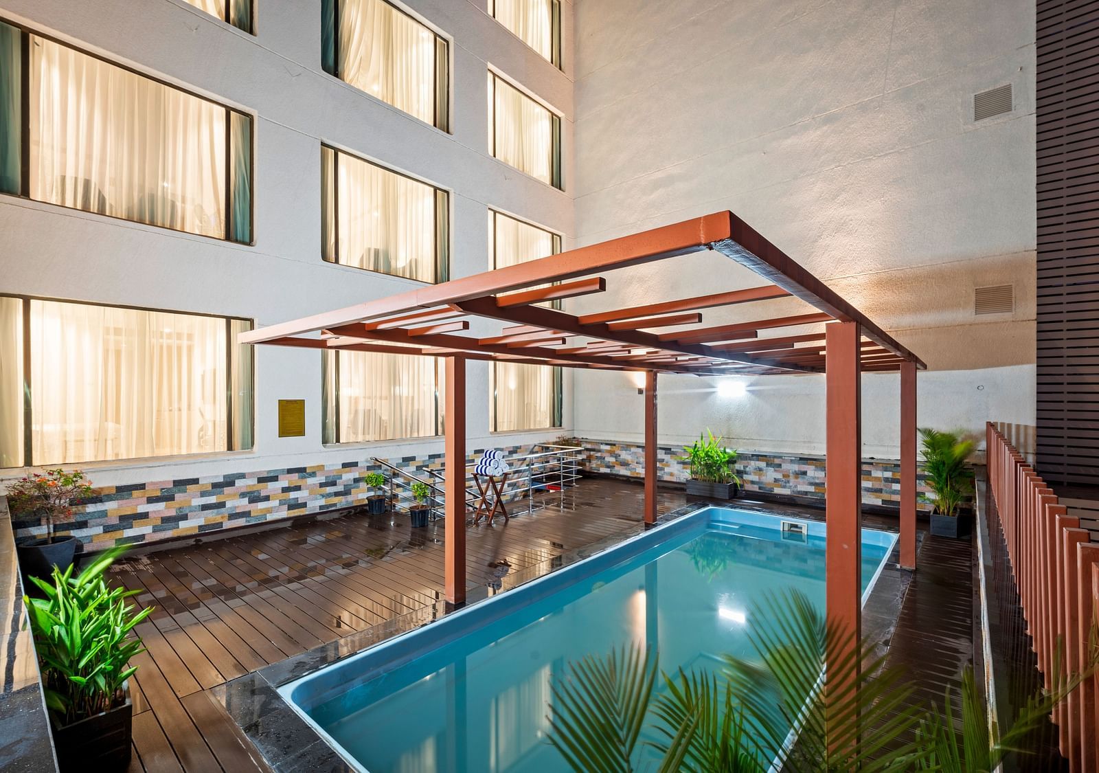 An image of a swimming pool at night of Grand Vijayawada by GRT Hotels.