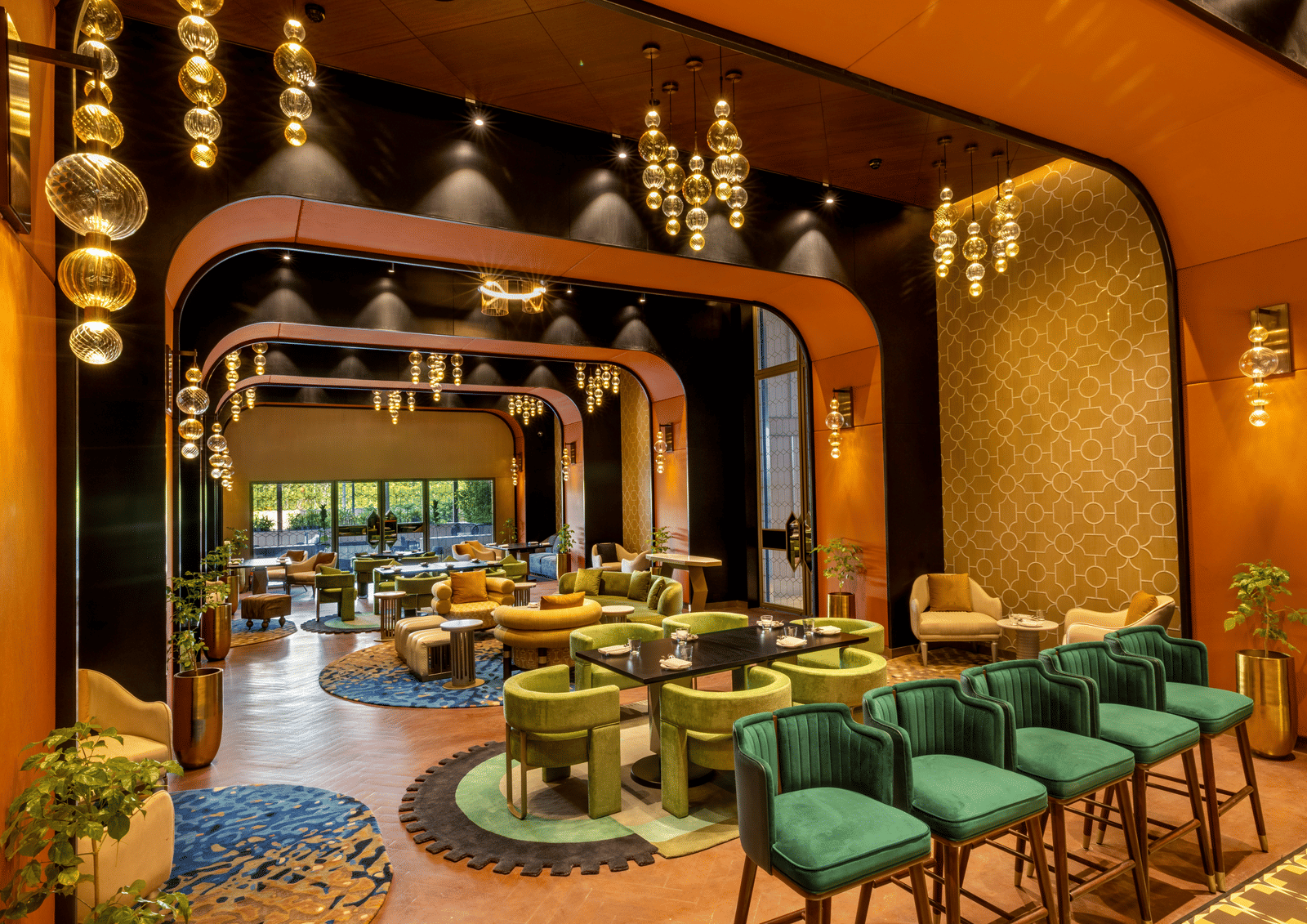 A exquisite restaurant in Madurai with warm ambient lighting and modern seating arrangement - Grand Madurai by GRT Hotels